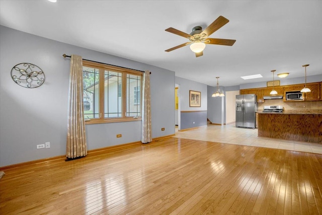 13610 S 84th Ave, Orland Park, IL 60462 - unfurnished living room with light wood finished floors and a ceiling fan