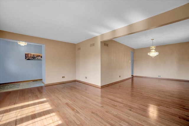 13610 S 84th Ave, Orland Park, IL 60462 - unfurnished room with a chandelier and light wood-style floors