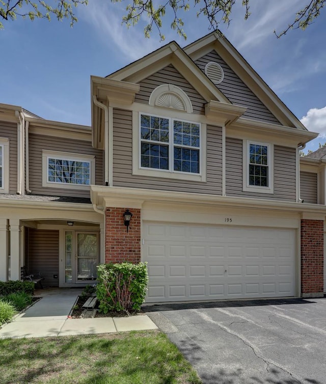 195 Island Ct Unit 195, Schaumburg, IL 60193 - view of front of property with a garage, brick siding, and driveway