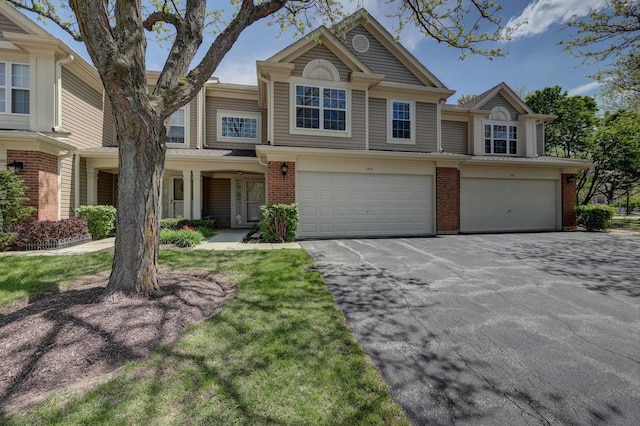 195 Island Ct Unit 195, Schaumburg, IL 60193 - view of property featuring driveway, a garage, and brick siding