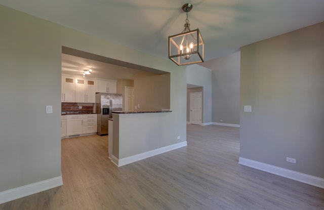 195 Island Ct Unit 195, Schaumburg, IL 60193 - kitchen with stainless steel refrigerator with ice dispenser, a chandelier, white cabinets, light wood-type flooring, and glass insert cabinets