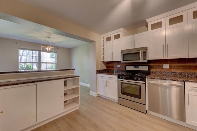 195 Island Ct Unit 195, Schaumburg, IL 60193 - kitchen with appliances with stainless steel finishes, backsplash, white cabinetry, dark stone counters, and light wood-style floors
