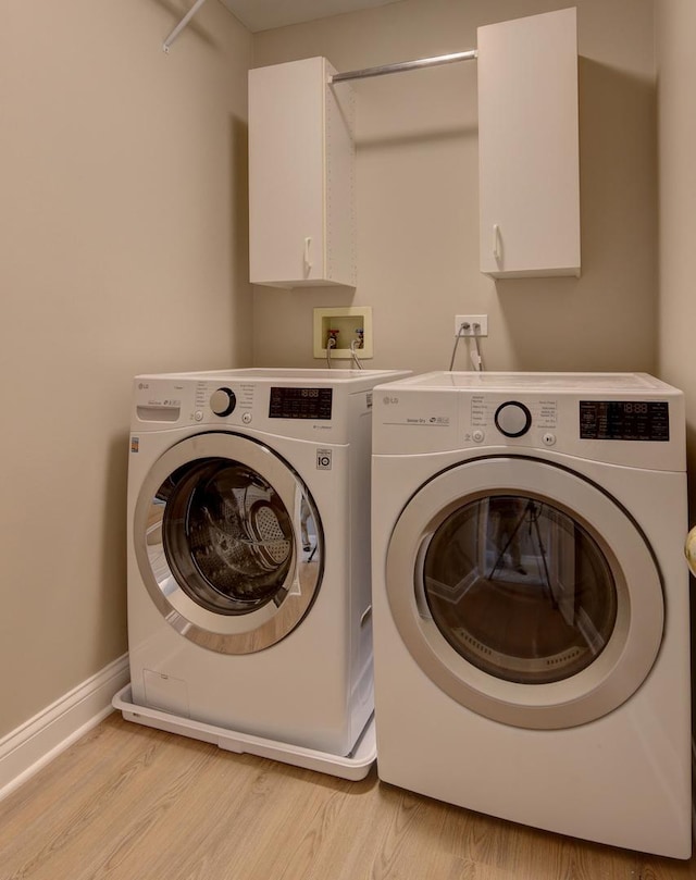 195 Island Ct Unit 195, Schaumburg, IL 60193 - washroom featuring washer and dryer, cabinet space, and light wood-style floors
