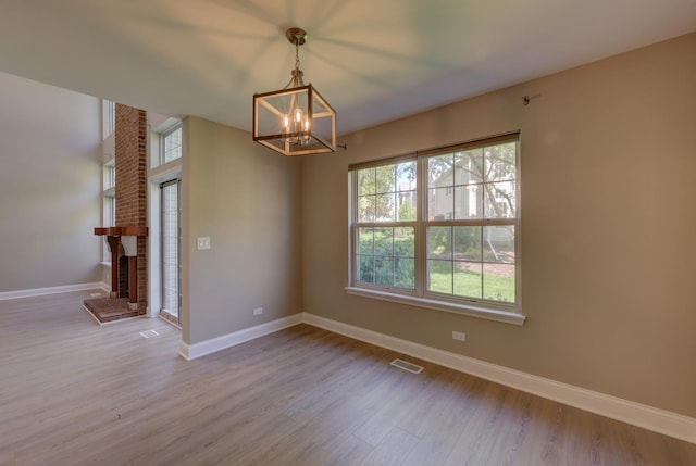 195 Island Ct Unit 195, Schaumburg, IL 60193 - empty room with a chandelier, wood finished floors, and a fireplace