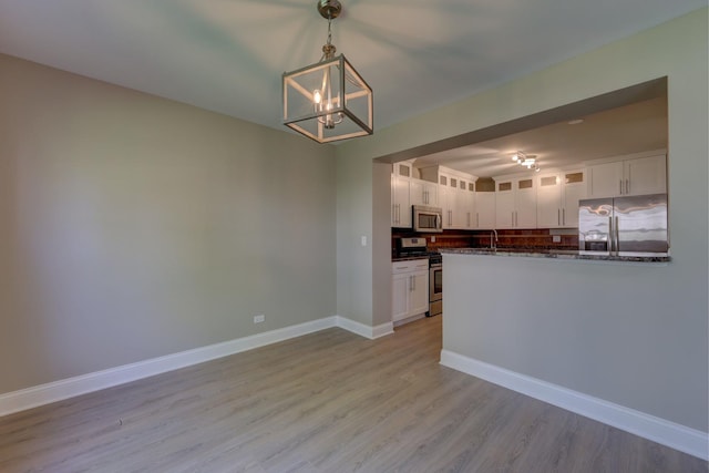 195 Island Ct Unit 195, Schaumburg, IL 60193 - kitchen featuring appliances with stainless steel finishes, a chandelier, light wood-style floors, and white cabinets