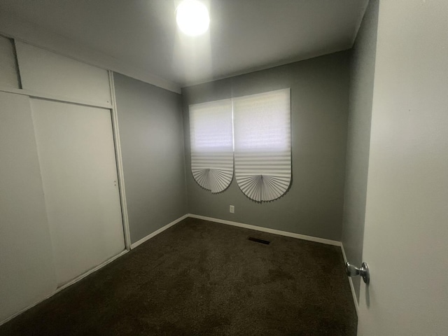 16939 Jodave Ave, Hazel Crest, IL 60429 - unfurnished bedroom featuring dark colored carpet and a closet