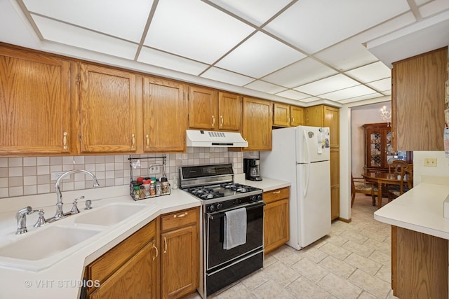6419 Oak Forest Ave Unit 1N, Tinley Park, IL 60477 - kitchen featuring black gas range, under cabinet range hood, freestanding refrigerator, brown cabinetry, and light countertops