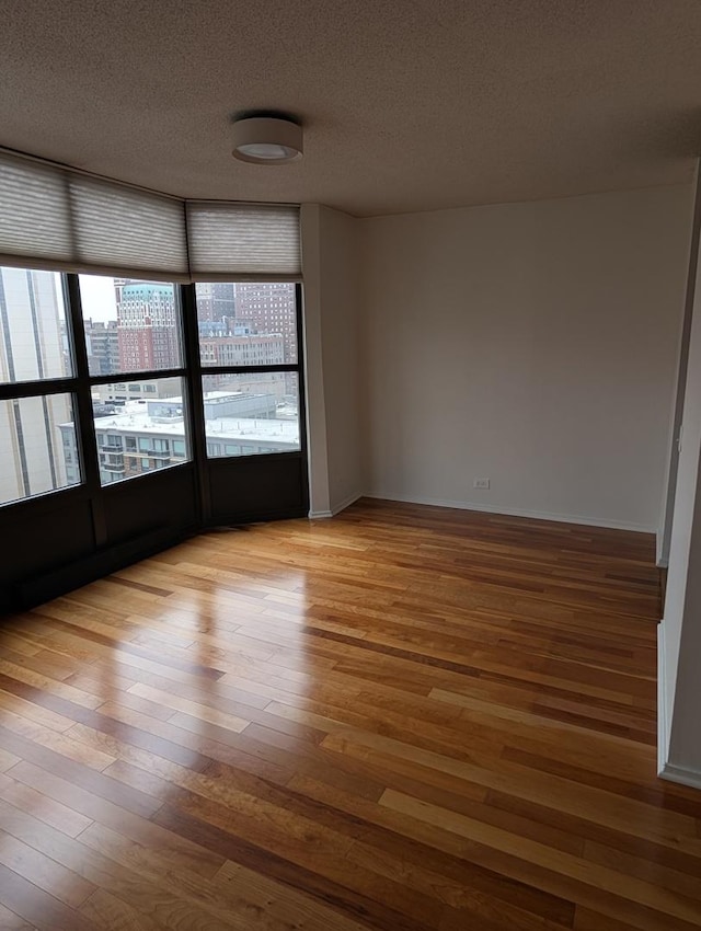 899 S Plymouth Ct Unit 1703, Chicago, IL 60605 - unfurnished room featuring wood finished floors and a textured ceiling