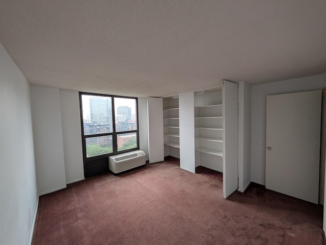 899 S Plymouth Ct Unit 1703, Chicago, IL 60605 - unfurnished bedroom featuring carpet flooring, a wall mounted air conditioner, and a textured ceiling