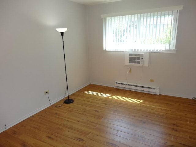 828 E Old Willow Rd Unit 109, Prospect Heights, IL 60070 - unfurnished room featuring a baseboard radiator, a wall unit AC, and wood finished floors