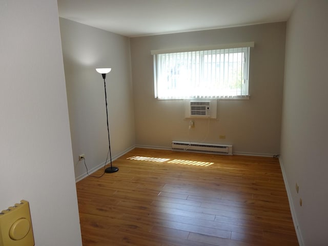 828 E Old Willow Rd Unit 109, Prospect Heights, IL 60070 - empty room featuring a baseboard heating unit, a wall mounted air conditioner, and hardwood / wood-style floors