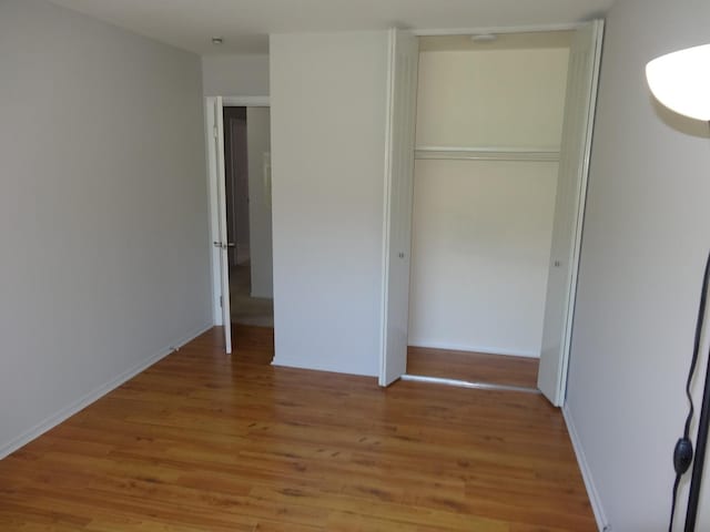 828 E Old Willow Rd Unit 109, Prospect Heights, IL 60070 - unfurnished bedroom with light wood-style flooring and a closet