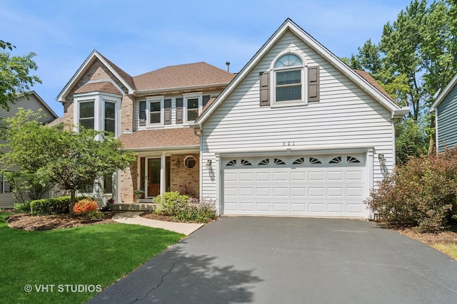 321 Breckenridge Dr, Aurora, IL 60504 - traditional-style home with driveway, brick siding, a garage, a porch, and a front yard