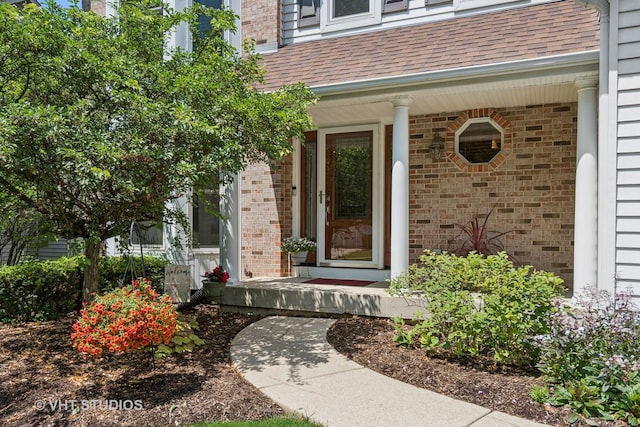 321 Breckenridge Dr, Aurora, IL 60504 - property entrance with a porch, brick siding, and roof with shingles