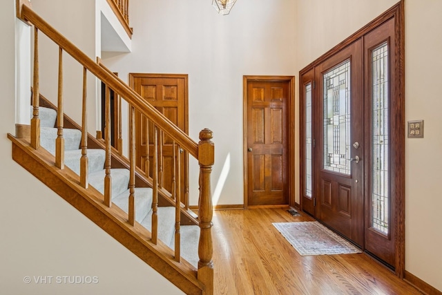 321 Breckenridge Dr, Aurora, IL 60504 - entrance foyer with light wood-style floors, stairway, and a towering ceiling