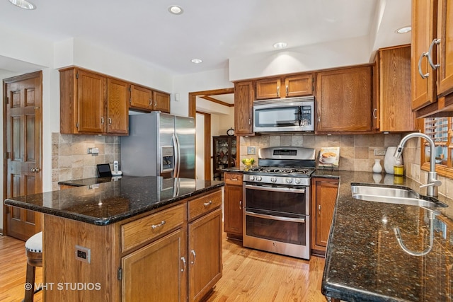 321 Breckenridge Dr, Aurora, IL 60504 - kitchen featuring appliances with stainless steel finishes, light wood finished floors, decorative backsplash, brown cabinets, and recessed lighting