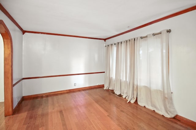 8619 S Jeffery Blvd, Chicago, IL 60617 - unfurnished room featuring ornamental molding, wood finished floors, and arched walkways