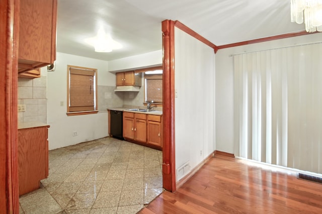 8619 S Jeffery Blvd, Chicago, IL 60617 - kitchen with light countertops, dishwasher, a chandelier, brown cabinetry, and decorative backsplash