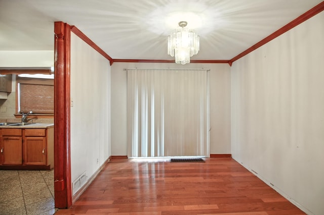 8619 S Jeffery Blvd, Chicago, IL 60617 - unfurnished dining area featuring crown molding, a chandelier, and wood finished floors