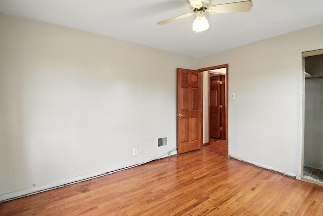 8619 S Jeffery Blvd, Chicago, IL 60617 - unfurnished bedroom with light wood-style floors and a ceiling fan