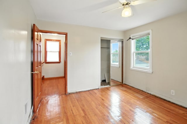8619 S Jeffery Blvd, Chicago, IL 60617 - unfurnished bedroom featuring light wood finished floors, a closet, and ceiling fan