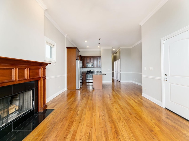 5445 N NW Hwy Unit 3N, Chicago, IL 60630 - unfurnished living room featuring a tile fireplace, ornamental molding, recessed lighting, and light wood-type flooring
