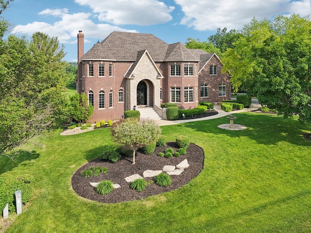 6N707 Brookhaven Ln, Saint Charles, IL 60175 - view of front of house featuring brick siding, a chimney, and a front yard