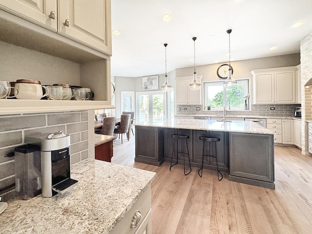 6N707 Brookhaven Ln, Saint Charles, IL 60175 - kitchen with decorative backsplash, light wood finished floors, light stone counters, and recessed lighting