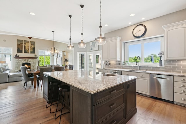 6N707 Brookhaven Ln, Saint Charles, IL 60175 - kitchen with dishwasher, a fireplace, white cabinetry, backsplash, and recessed lighting