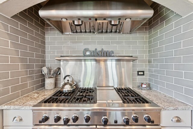 6N707 Brookhaven Ln, Saint Charles, IL 60175 - kitchen featuring exhaust hood, range, tasteful backsplash, and light stone countertops
