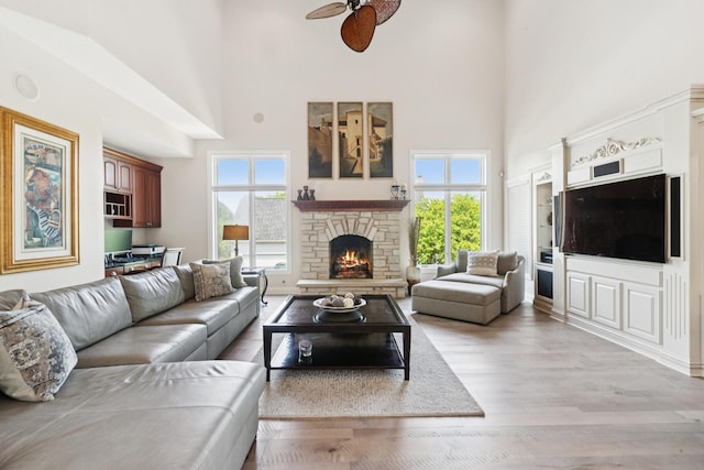 6N707 Brookhaven Ln, Saint Charles, IL 60175 - living room with a high ceiling, ceiling fan, a fireplace, plenty of natural light, and light wood-style flooring