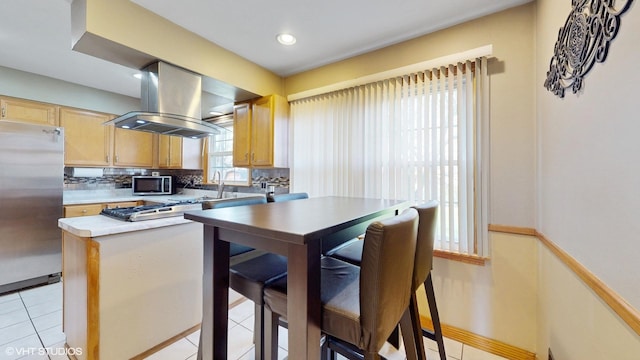 1416 S Robert Dr, Mount Prospect, IL 60056 - kitchen with island exhaust hood, appliances with stainless steel finishes, backsplash, light tile patterned floors, and light countertops