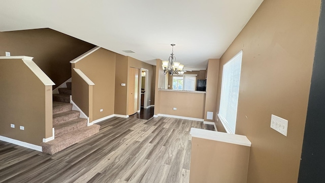 2434 Roxbury Ln, Montgomery, IL 60538 - unfurnished dining area featuring a chandelier, wood finished floors, and stairs