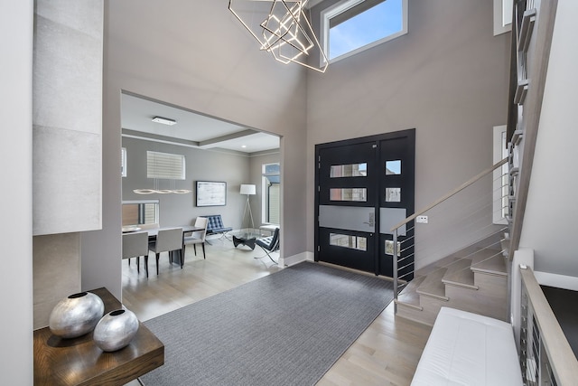 2412 Sharon Ct, Naperville, IL 60564 - entryway featuring wood finished floors, a chandelier, stairway, and plenty of natural light