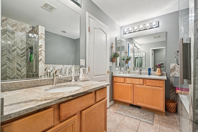147 Fulbright Ln, Schaumburg, IL 60194 - full bath featuring two vanities, tile patterned flooring, and a tile shower