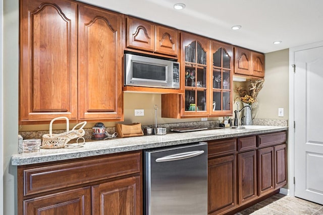 147 Fulbright Ln, Schaumburg, IL 60194 - kitchen featuring appliances with stainless steel finishes, glass insert cabinets, recessed lighting, and brown cabinetry