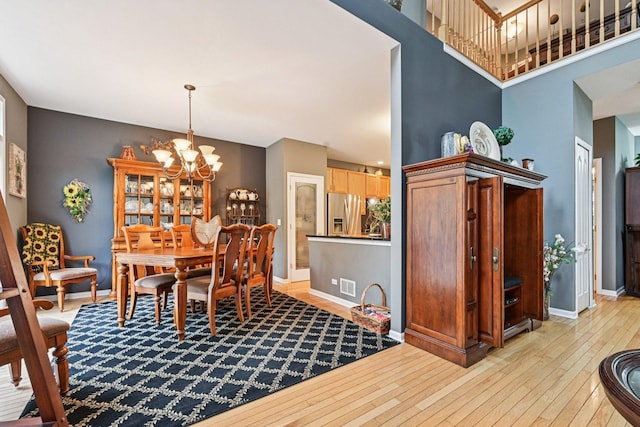 147 Fulbright Ln, Schaumburg, IL 60194 - dining area with light wood finished floors and a chandelier