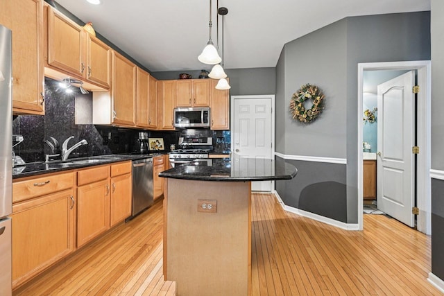 147 Fulbright Ln, Schaumburg, IL 60194 - kitchen with appliances with stainless steel finishes, light wood-style floors, tasteful backsplash, and a center island