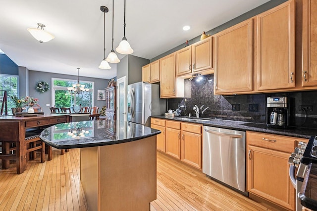 147 Fulbright Ln, Schaumburg, IL 60194 - kitchen with stainless steel appliances, light wood-style floors, backsplash, a chandelier, and a kitchen island