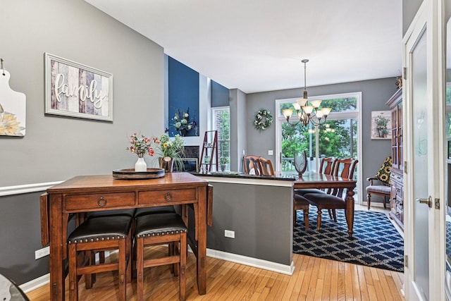 147 Fulbright Ln, Schaumburg, IL 60194 - dining room with light wood-style flooring and a chandelier