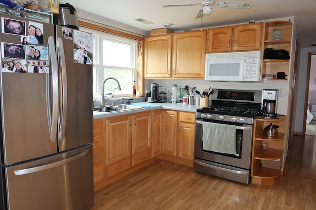 5125 N La Crosse Ave, Chicago, IL 60630 - kitchen with stainless steel appliances, open shelves, light wood-style flooring, ceiling fan, and light countertops