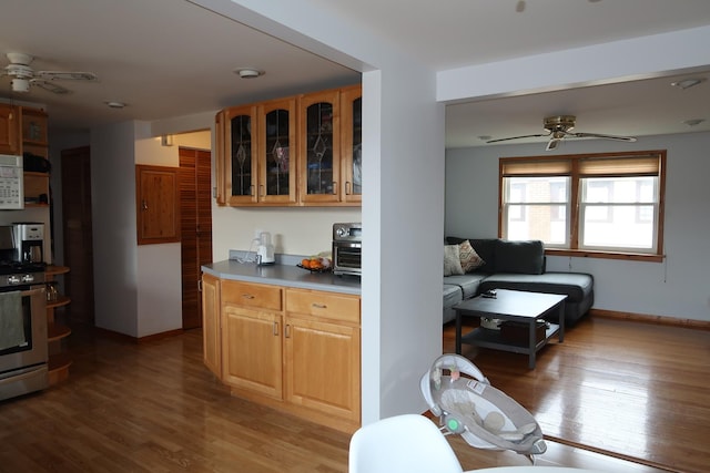 5125 N La Crosse Ave, Chicago, IL 60630 - kitchen featuring ceiling fan, white microwave, stainless steel range, and light wood finished floors