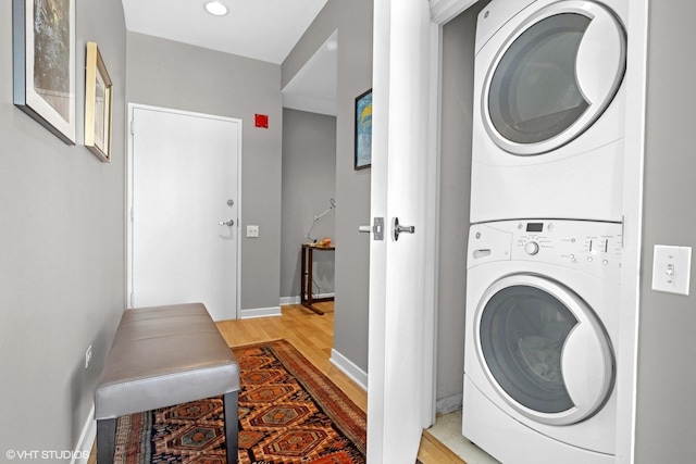 653 N Kingsbury St Unit 2202, Chicago, IL 60654 - washroom featuring estacked washer and dryer and light wood finished floors