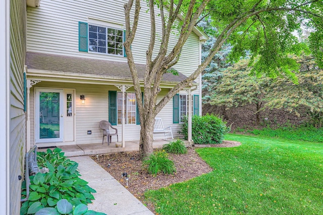 28 W Pheasant Trl Unit 28, Lake In The Hills, IL 60156 - doorway to property featuring a porch, a lawn, and roof with shingles