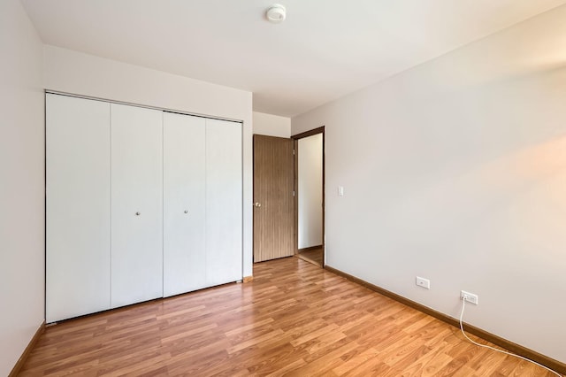 28 W Pheasant Trl Unit 28, Lake In The Hills, IL 60156 - unfurnished bedroom with a closet and light wood-style floors