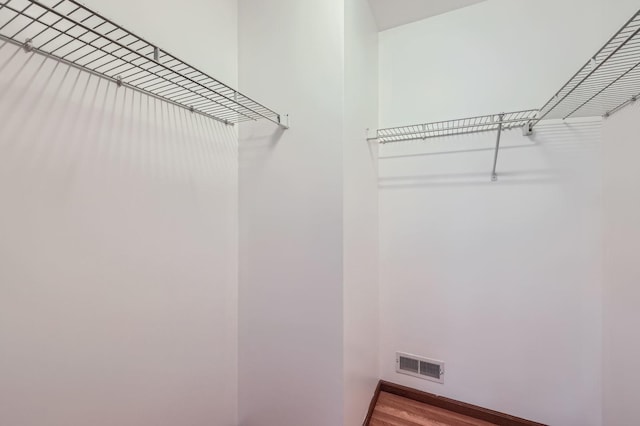 28 W Pheasant Trl Unit 28, Lake In The Hills, IL 60156 - walk in closet featuring wood finished floors