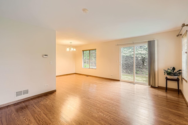 28 W Pheasant Trl Unit 28, Lake In The Hills, IL 60156 - spare room with a chandelier, light wood finished floors, and healthy amount of natural light