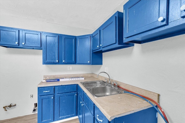 1413 Garden Hills Dr, Champaign, IL 61821 - kitchen featuring blue cabinets, light countertops, and light wood-style flooring