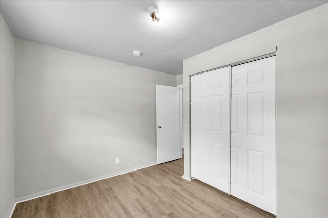 1413 Garden Hills Dr, Champaign, IL 61821 - unfurnished bedroom featuring wood finished floors and a closet