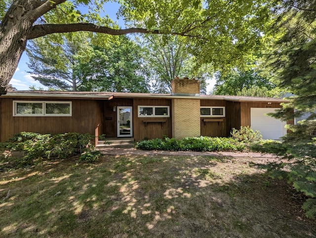 1437 S Plum Ave, Freeport, IL 61032 - view of front facade featuring an attached garage, a chimney, and brick siding